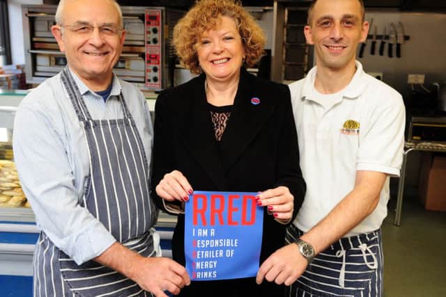 Norma Austin Hart presents Dante Cortellessa, pictured with his father Angelo, with a RRED award. Picture: Ian Rutherford