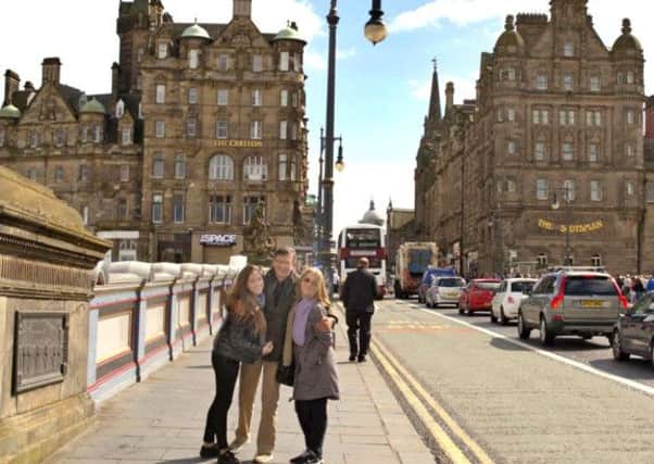 The photos include images of the family on North Bridge (pictured), at the Castle and outside the Ibis Hotel at Edinburgh Park