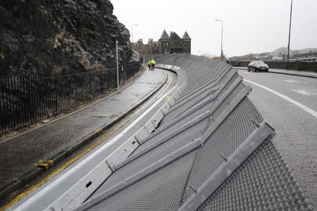 The Edinburgh Castle barrier put up on Johnston Terrace to protect people and cars from falling rocks has been tipped over by the high winds. Pic: Greg Macvean