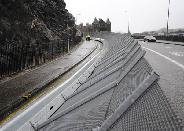 The Edinburgh Castle barrier put up on Johnston Terrace to protect people and cars from falling rocks has been tipped over by the high winds. Pic: Greg Macvean
