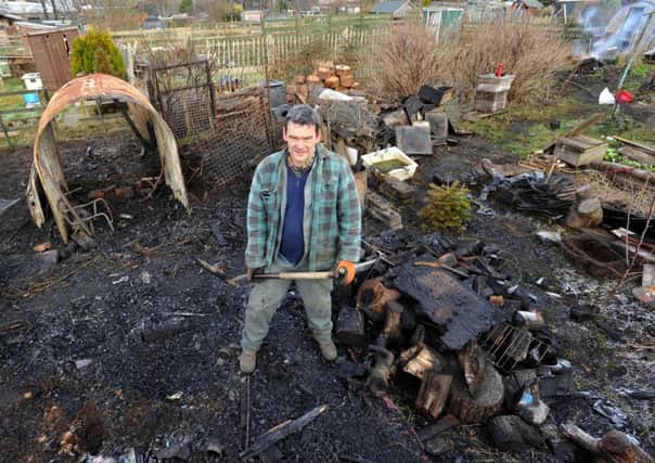 Bob Will assesses the damage after his allotment shed and beehives were set alight. Picture: Ian Rutherford