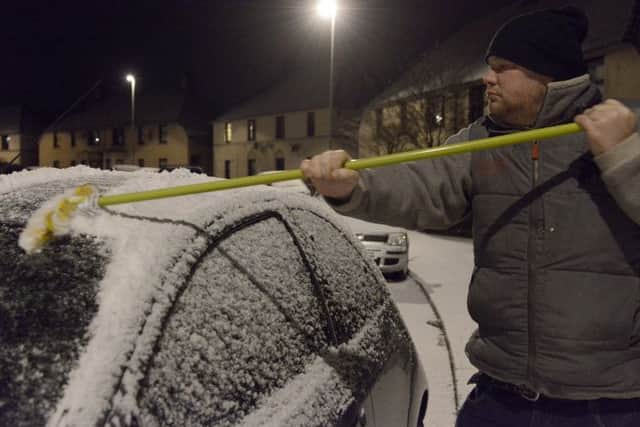 Mark McCaffer clears his car in Dalkeith.