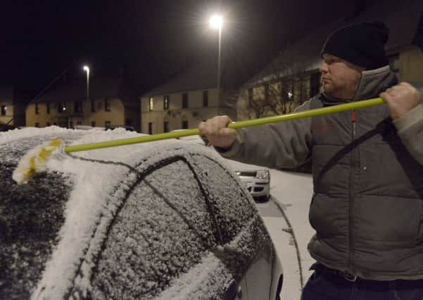 Mark McCaffer clears his car in Dalkeith.