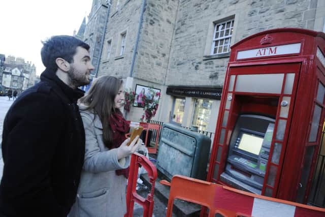 The famous telephone boxes now contain cash machines. Picture: Greg Macvean