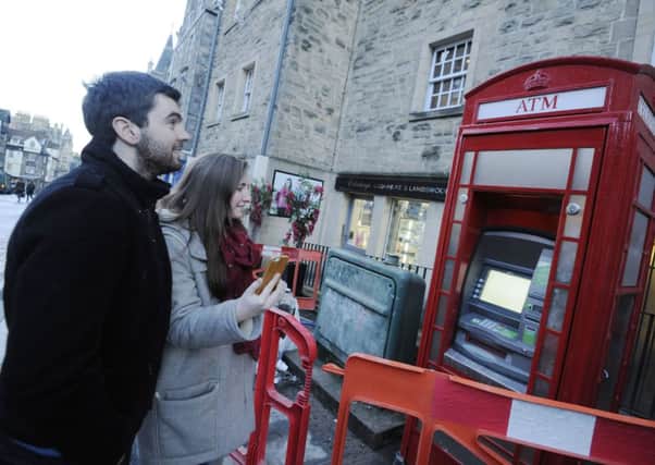 The famous telephone boxes now contain cash machines. Picture: Greg Macvean