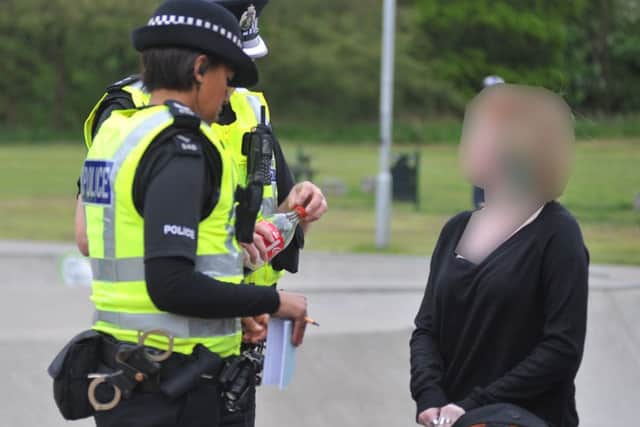 Officers carry out a stop-and-search on the streets. Picture: George McLuskie