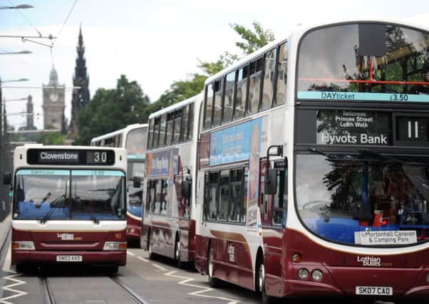 Picture by JANE BARLOW. 7th August 2013. Buses along Princes Street, Edinburgh.