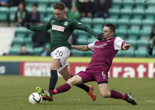 Hibernian's Scott Allan (left) is challenged by Mark Whatley. Picture: SNS Group