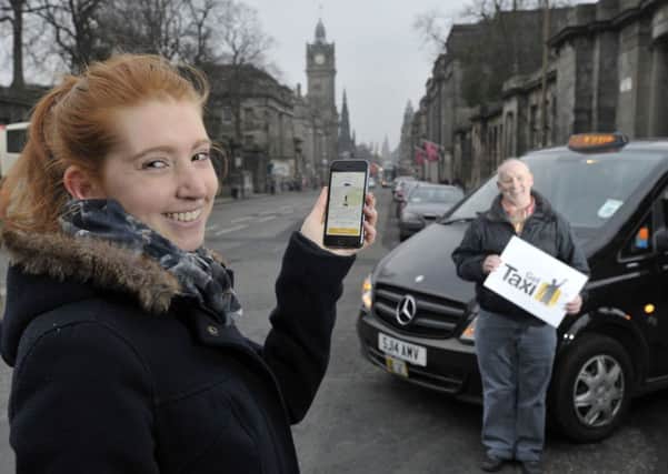 Student Lara Magyar tries out the new taxi app with the help of taxi driver  David Sutherland. Picture: Ian Rutherford