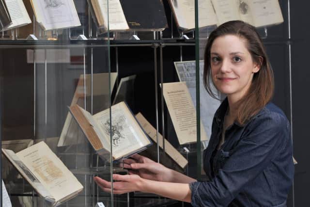 Curator Dora Petherbridge examines some of the artefacts on display in the Yankee Cries and Rebel Yells exhibition. Picture: Ian Rutherford