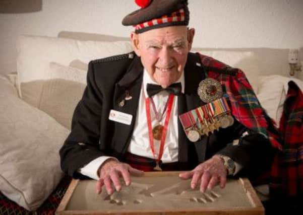 Tom Gilzean has had a print of his hands taken. Picture: Comp