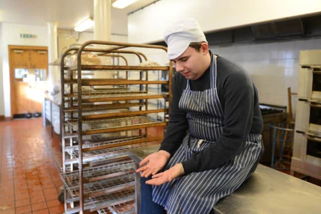 Trainees clean the Engine Shed kitchen for the last time. Picture: Neil Hanna