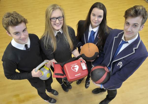 Ricky Kerr and Jordan Rowlands from Forrester High join Georgie Purvis and Cristiano Crolla from St Augustine's at the schools' sports hub to receive a defibrillator. Picture: Ian Rutherford