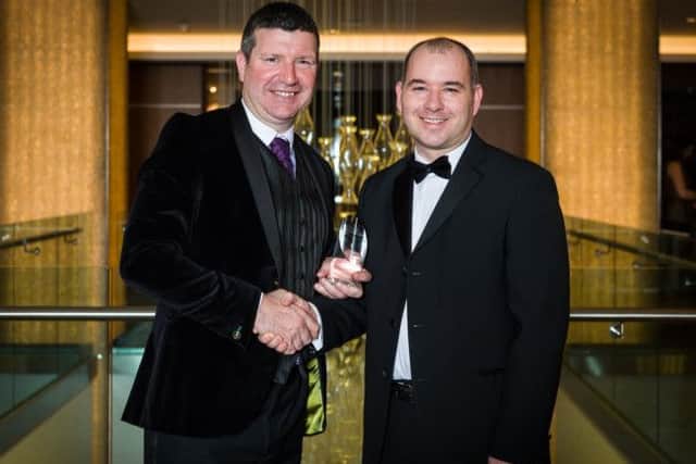 Edinburgh Airport's Gordon Dewar receives his award from Kevin Havelock. Picture: contributed