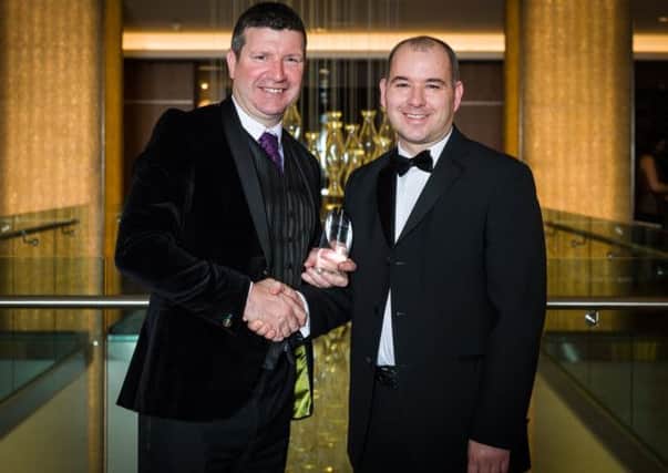 Edinburgh Airport's Gordon Dewar receives his award from Kevin Havelock. Picture: contributed