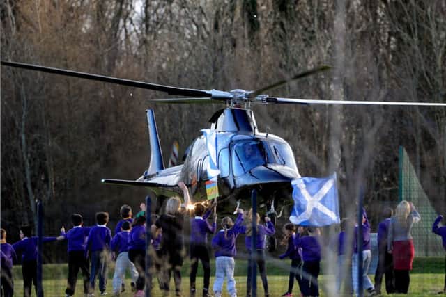 David Walliams is given an enthusiastic send-off  as his helicopter made good use of the playing field. Picture: Lisa Ferguson