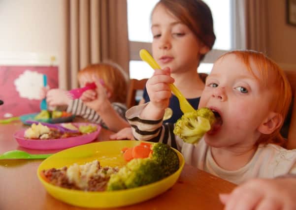 Leigh Bishop serves up a healthy shepherds pie to children Alex, Amelia and Ava while they tuck in to some fresh vegetables. Picture: Phil Wilkinson
