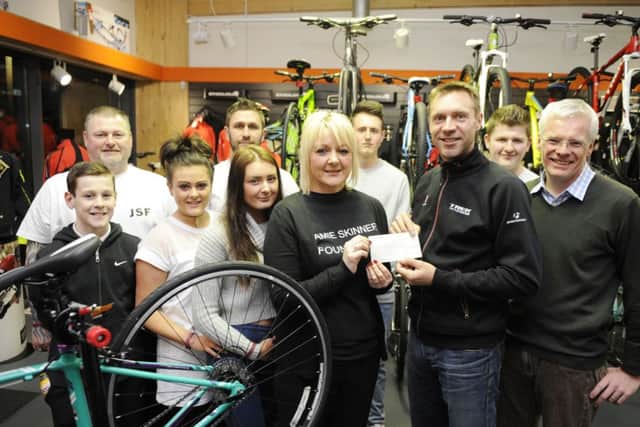 Karen Greechan with Jens Voights and Richard Bowker, right, from the Criterium Cycle Company. Picture: Greg Macvean