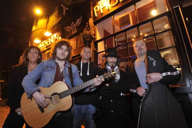 Phoenix bar owners Sam Roberts and Gareth Roberts, centre, joined by local musicians. Picture: Phil Wilkinson