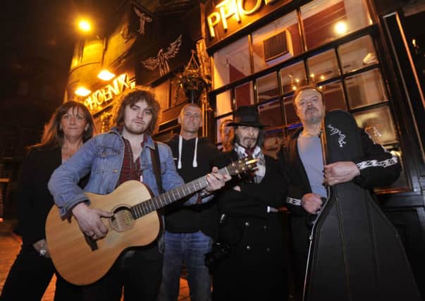 Phoenix bar owners Sam Roberts and Gareth Roberts, centre, joined by local musicians. Picture: Phil Wilkinson