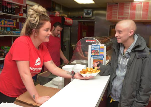 Jane Park serves chips to Leon Remndle. Picture: Phil Wilkinson