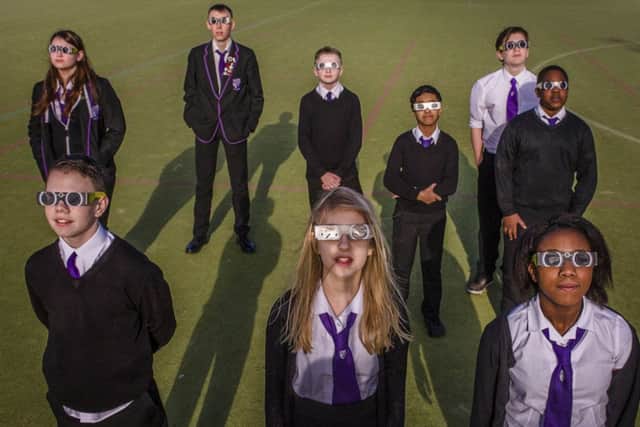 Holyrood High School pupils watch the eclipse through solar glasses. Picture: Steven Scott Taylor
