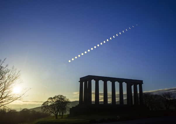 A composite photograph showing the eclipse of the sun over Calton Hill in Edinburgh. Picture: PA