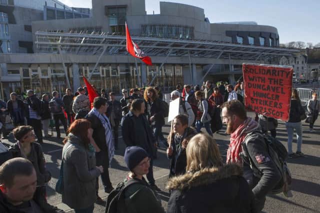 Members of the public protesting against the Pagida march gathered at the Scottish Parliament. Picture: Toby Williams
