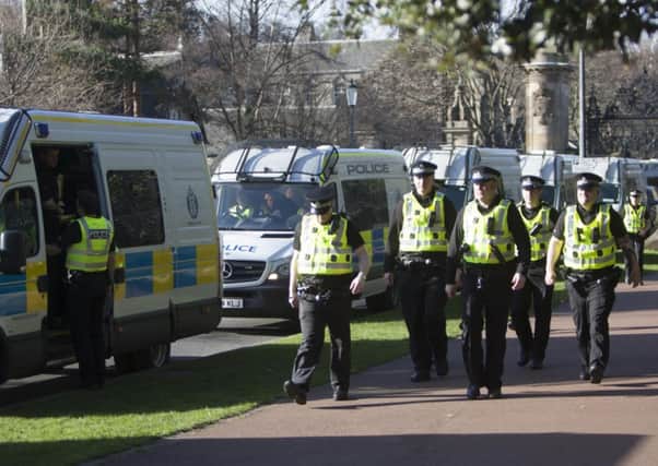 Police prepare to leave after only four people turned up for the march. Picture: Toby Williams