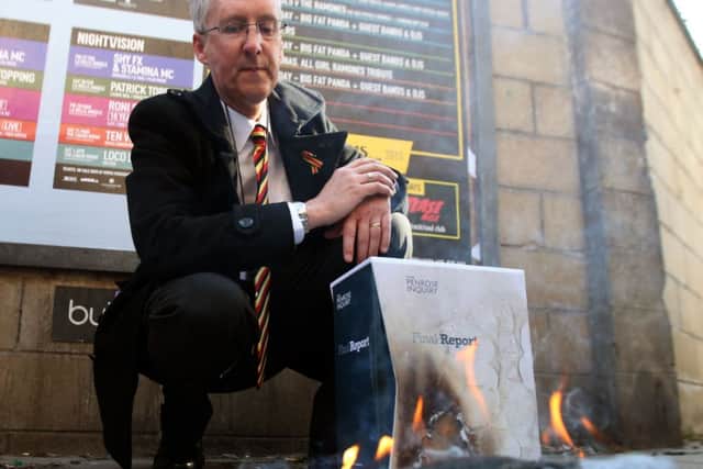 Campaigner Glenn Wilkinson burns the report. Picture: PA