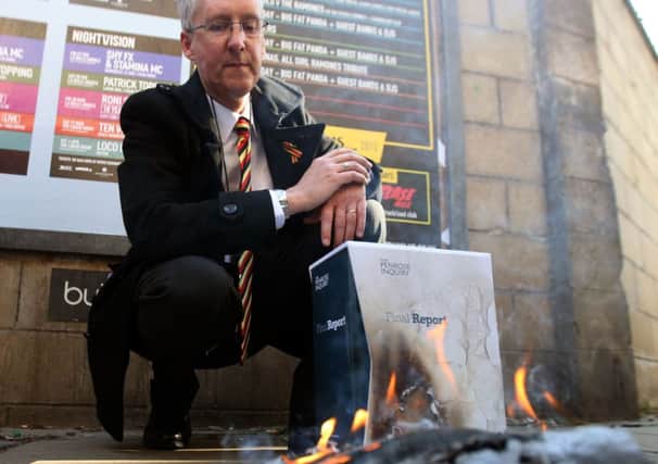 Campaigner Glenn Wilkinson burns the report. Picture: PA
