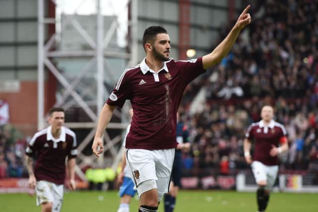 A delighted Alim Ozturk celebrates his goal in front of the Hearts fans. Picture: SNS