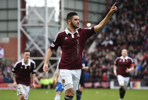 A delighted Alim Ozturk celebrates his goal in front of the Hearts fans. Picture: SNS