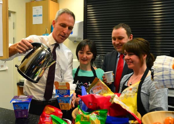 Scottish Labour party leader Jim Murphy prepares a kettle box food parcel with Ian Murray at Inch Park Community Sports Hub. Picture: PA