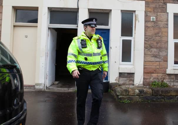 An officer remained on the scene while the majority of police left. Picture: Toby Williams