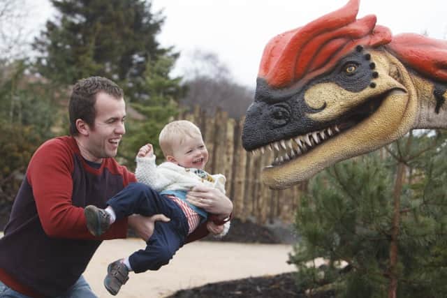 Jonathan Purves and one-year-old Toby meet the dinosaurs. Picture: Toby Williams