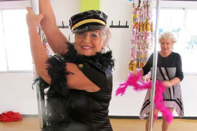 Pat Ingles all dressed up and pole-dancing. Picture: Comp
