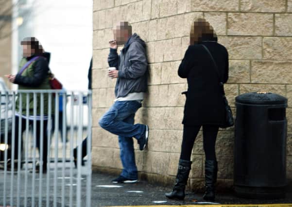 Smokers outside the hospital. Picture: Toby Williams