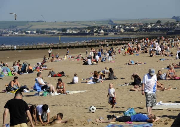 People flock to Portobello Beach to bathe in the sun. Picture: TSPL
