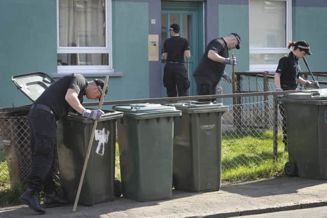 Police sweep the area for clues. Picture: Scott Taylor