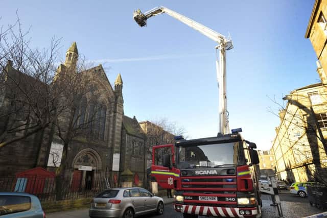 Firefighters with a cherry-picker at the scene. Picture: Ian Rutherford