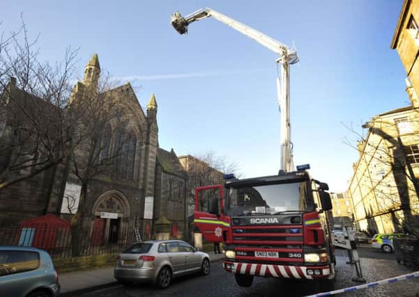 Firefighters with a cherry-picker at the scene. Picture: Ian Rutherford