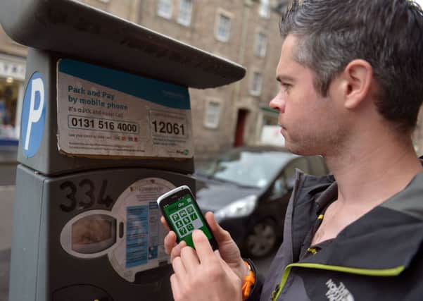 A driver uses the ringo phone app to pay for parking. Picture: Phil Wilkinson