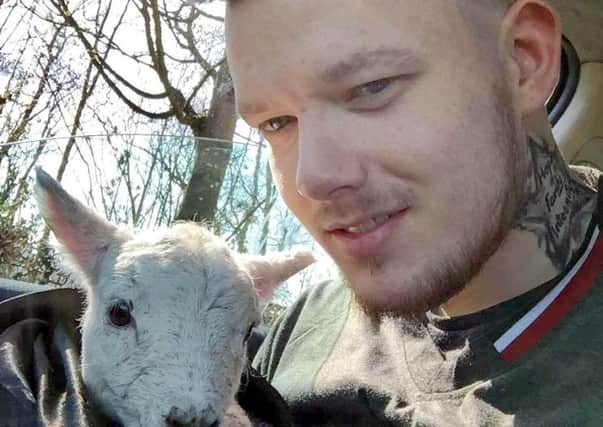 Alix Clarke with the lamb he rescued