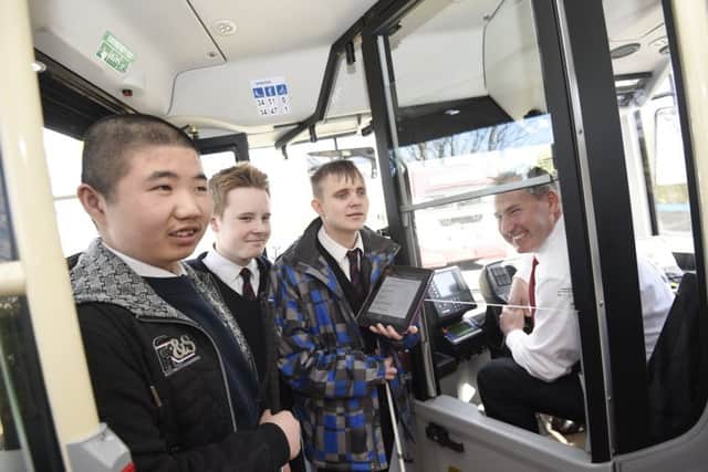 Royal Blind School pupils, from left, Junjie, Scott and Jake with Lothian Buses street supervisor David Adams. Picture: Greg Macvean