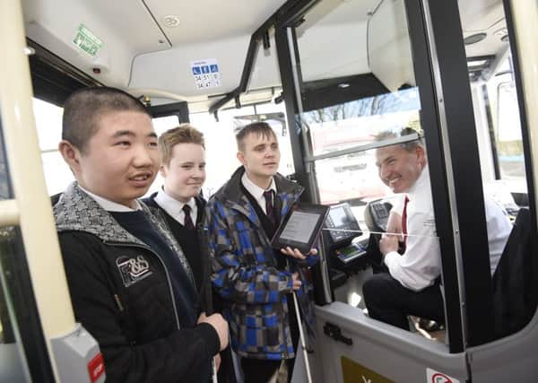 Royal Blind School pupils, from left, Junjie, Scott and Jake with Lothian Buses street supervisor David Adams. Picture: Greg Macvean