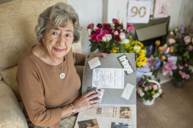 Gladys Bell looks over her scrapbook. Picture: Phil Wilkinson