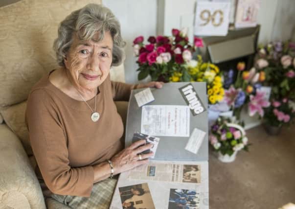 Gladys Bell looks over her scrapbook. Picture: Phil Wilkinson