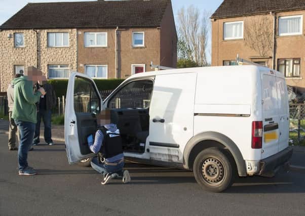 A van is searched during the police operation