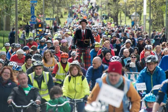 Pedal on Pariliament paricipants -including a man on stilts - make their way up Middle Meadow Walk. Picture: Andrew O'Brien